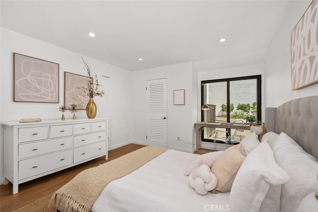 bedroom with dark wood finished floors, recessed lighting, baseboards, and access to exterior