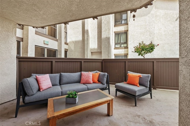 view of patio / terrace featuring an outdoor living space and fence