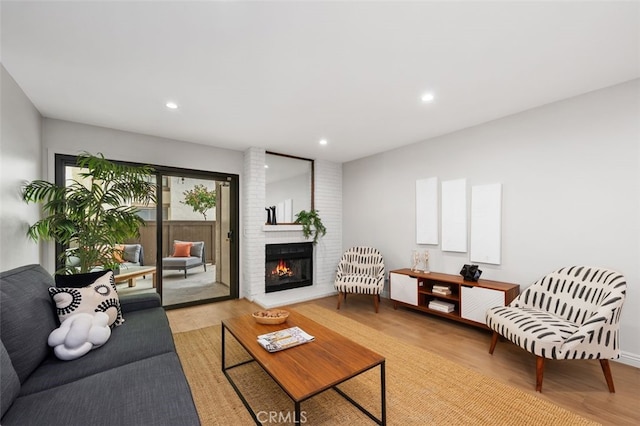 living room featuring recessed lighting, wood finished floors, and a fireplace