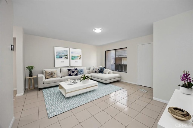 living room featuring light tile patterned floors and baseboards