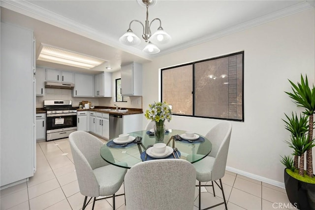 dining space with light tile patterned floors, baseboards, a notable chandelier, and crown molding