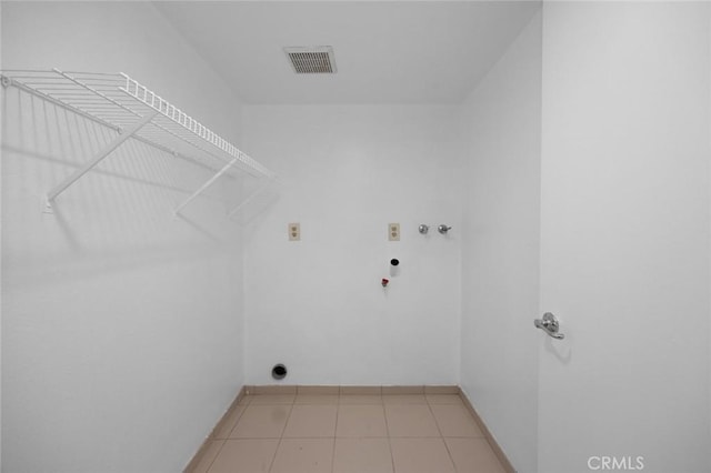 clothes washing area featuring visible vents, laundry area, light tile patterned flooring, washer hookup, and hookup for a gas dryer