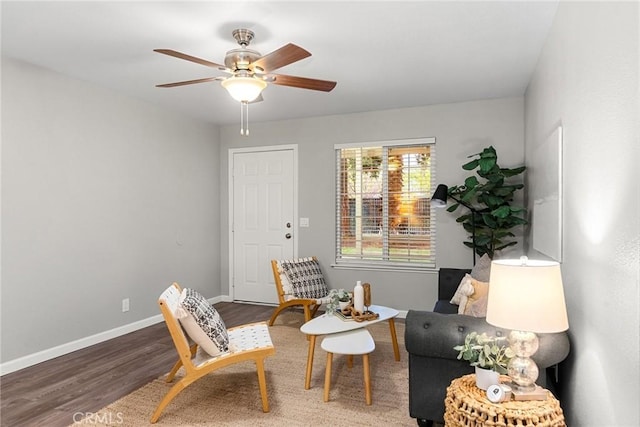 sitting room with wood finished floors, baseboards, and ceiling fan