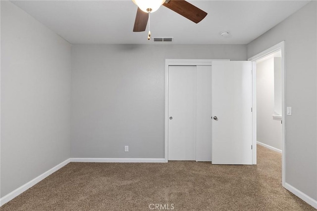 unfurnished bedroom featuring a closet, visible vents, carpet flooring, and baseboards