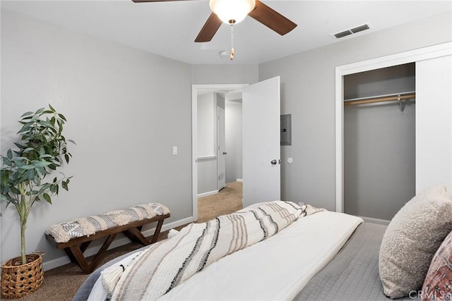 bedroom with a closet, visible vents, light colored carpet, and baseboards