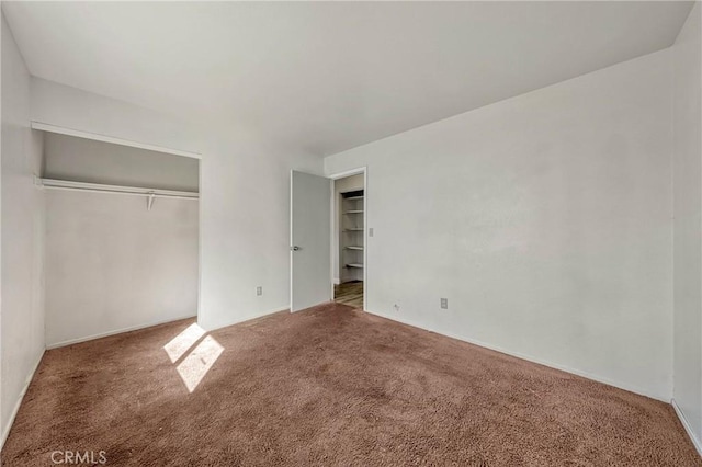 unfurnished bedroom with a closet and carpet flooring