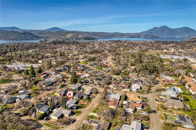 birds eye view of property with a water and mountain view