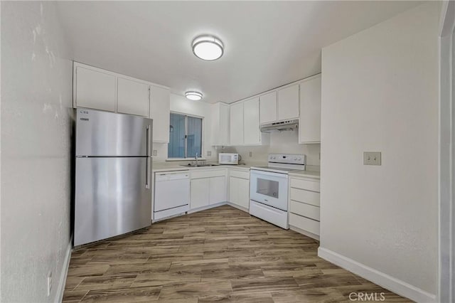 kitchen with white cabinetry, white appliances, wood finished floors, and under cabinet range hood