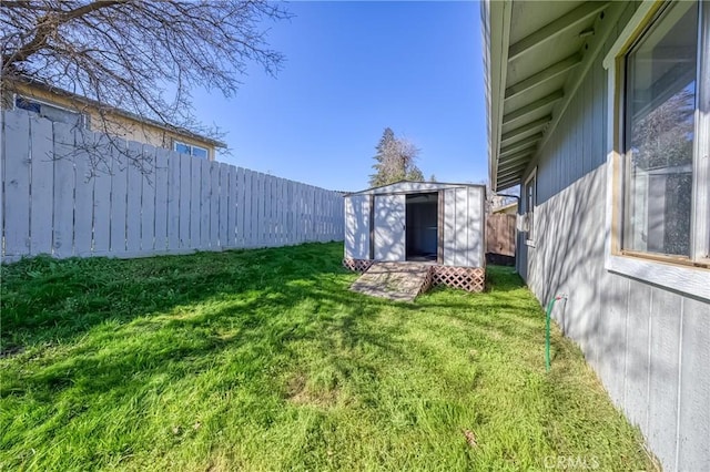 view of yard featuring an outdoor structure, a fenced backyard, and a shed