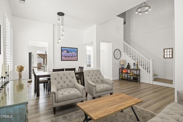 3012 Dunkirk Dr, Oxnard, CA 93035 - living room with stairway, baseboards, a towering ceiling, and wood finished floors