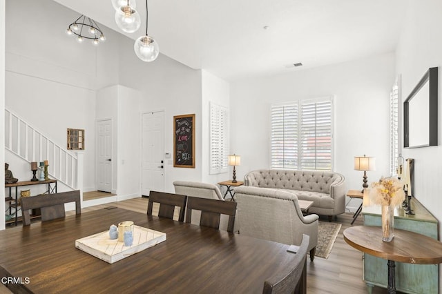 3012 Dunkirk Dr, Oxnard, CA 93035 - dining area with visible vents, baseboards, stairway, a towering ceiling, and wood finished floors
