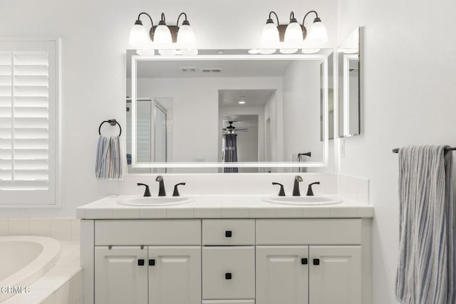 3012 Dunkirk Dr, Oxnard, CA 93035 - bathroom featuring a sink, a ceiling fan, a shower stall, and double vanity
