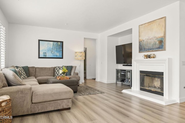 3012 Dunkirk Dr, Oxnard, CA 93035 - living area with a glass covered fireplace, baseboards, and wood finished floors