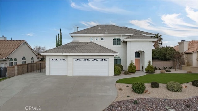 view of front of house with a front lawn, fence, concrete driveway, an attached garage, and a tiled roof