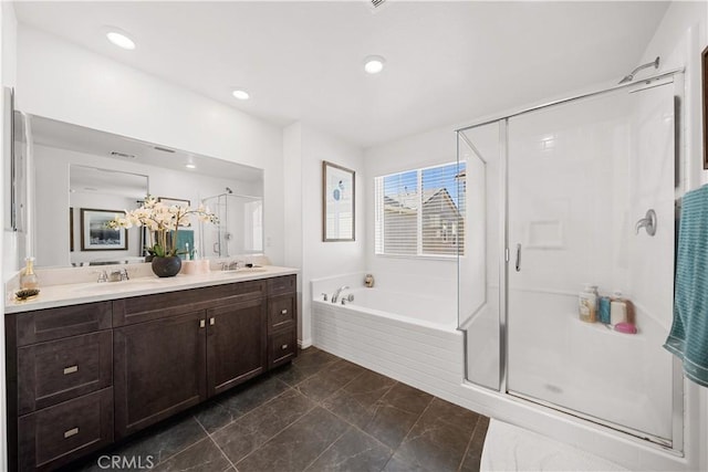 full bathroom featuring a bath, a stall shower, double vanity, and a sink