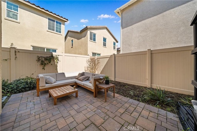 view of patio featuring an outdoor hangout area and a fenced backyard