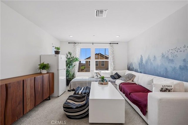 living area with light carpet and visible vents