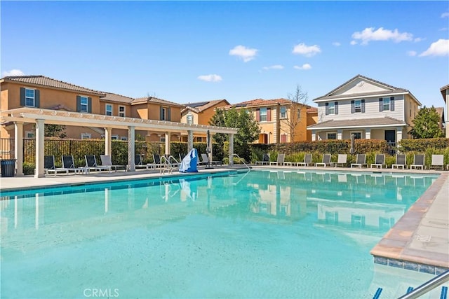 community pool featuring a pergola and fence