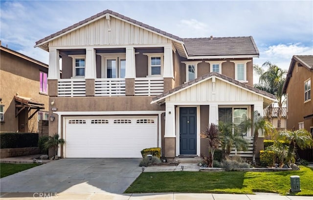 view of front of house with a balcony, an attached garage, concrete driveway, a tiled roof, and board and batten siding