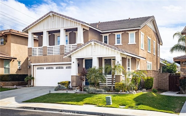 view of front of home with a balcony, an attached garage, concrete driveway, a front lawn, and board and batten siding