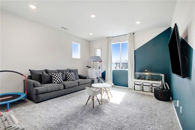 living area featuring recessed lighting, visible vents, and carpet flooring