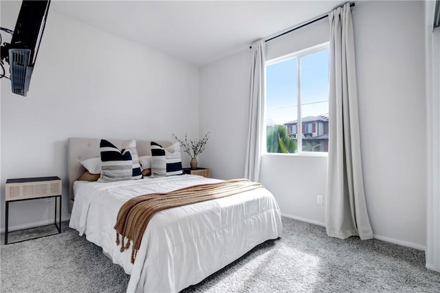 bedroom featuring carpet flooring and baseboards