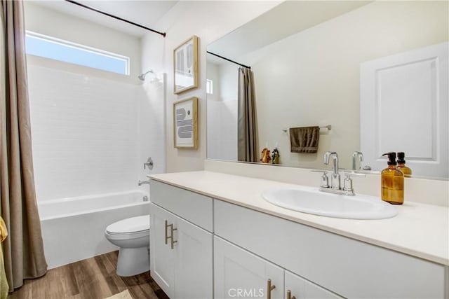 full bath with vanity, shower / tub combo, toilet, and wood finished floors