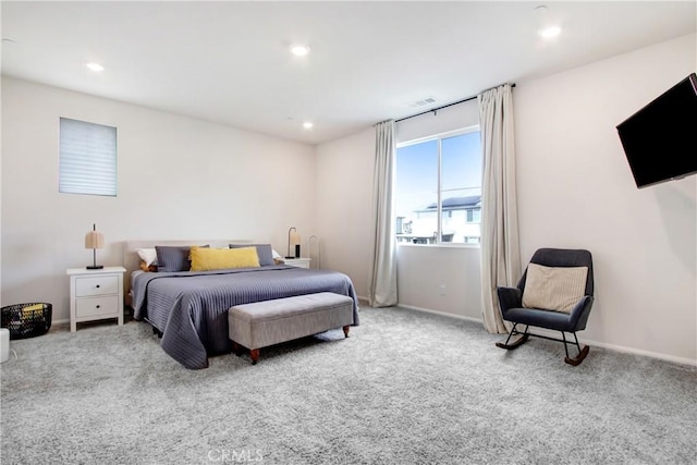 carpeted bedroom featuring recessed lighting, visible vents, and baseboards