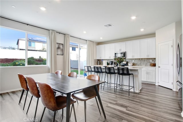 dining area featuring recessed lighting, light wood-style floors, and visible vents