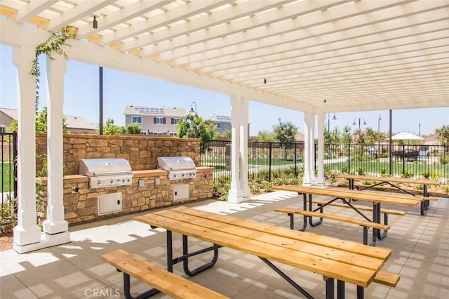 view of patio / terrace with outdoor dining area, area for grilling, exterior kitchen, and a pergola