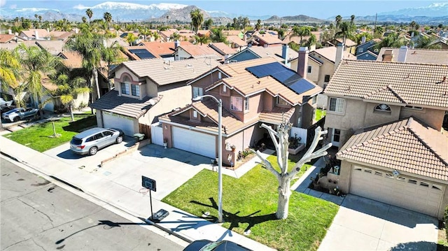 drone / aerial view featuring a residential view and a mountain view