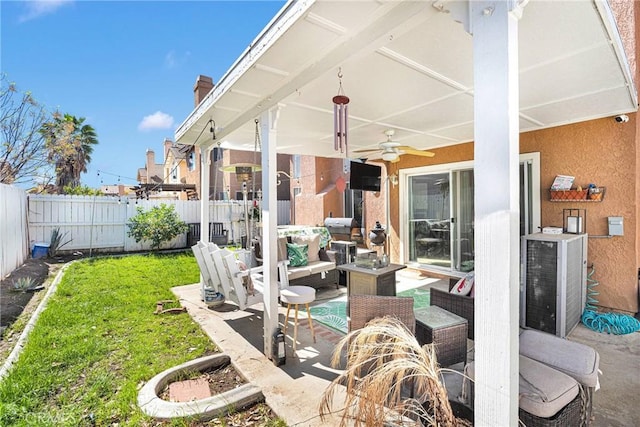 view of patio with ceiling fan, an outdoor hangout area, and a fenced backyard