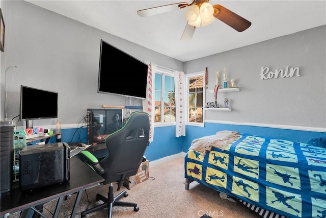 carpeted bedroom with baseboards and ceiling fan