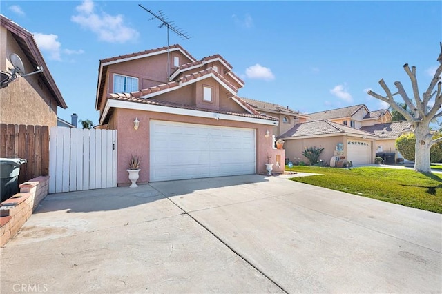 view of front of home featuring a front lawn, fence, a tiled roof, stucco siding, and driveway