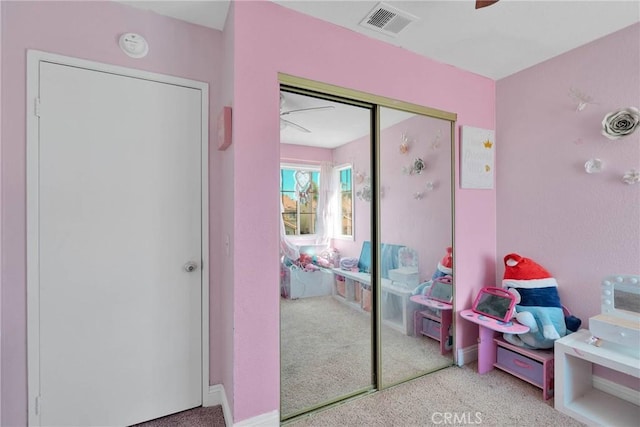 recreation room with visible vents, carpet, and a ceiling fan