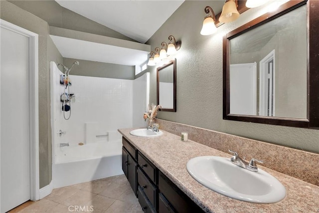 full bath with a sink, shower / tub combination, tile patterned floors, and vaulted ceiling