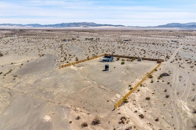 drone / aerial view featuring a mountain view, a rural view, and view of desert