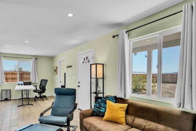 living area with recessed lighting, baseboards, and wood finished floors