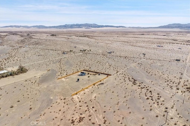 drone / aerial view with a mountain view, a rural view, and view of desert