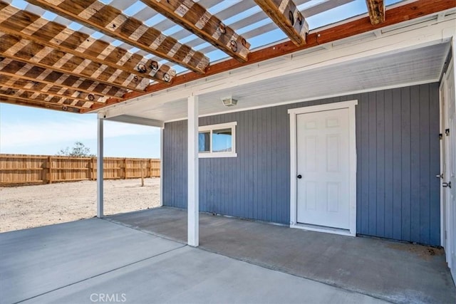 view of patio featuring a pergola and fence