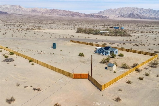 bird's eye view featuring a mountain view, a desert view, and a rural view