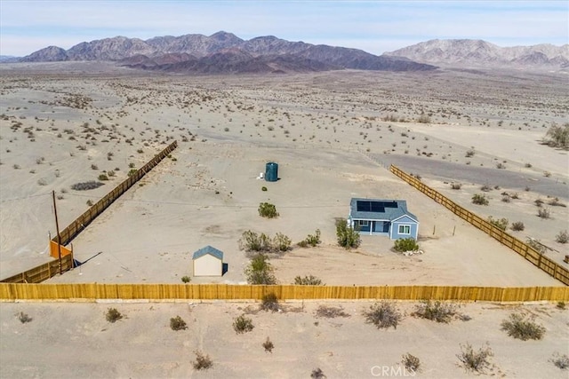 drone / aerial view featuring a desert view and a mountain view