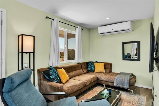 living room featuring recessed lighting, baseboards, wood finished floors, and a wall mounted AC