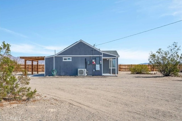 exterior space with ac unit and fence