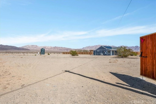 view of yard with a mountain view and fence