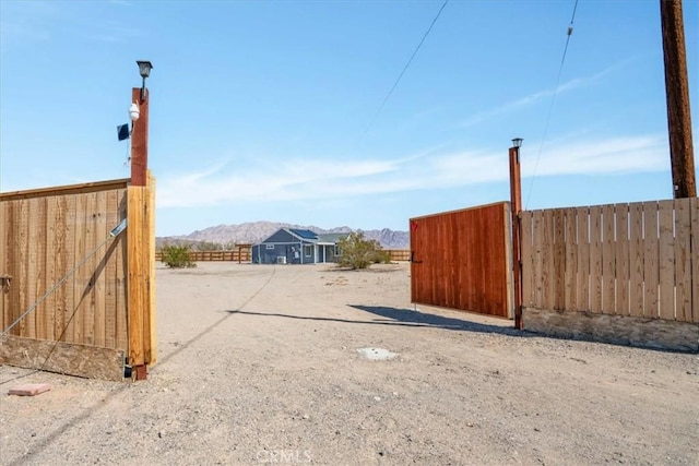 view of yard with fence and a mountain view