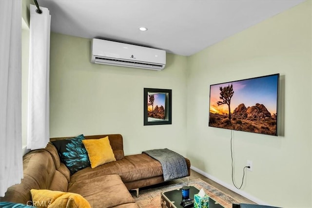 living area with recessed lighting, baseboards, and a wall mounted air conditioner