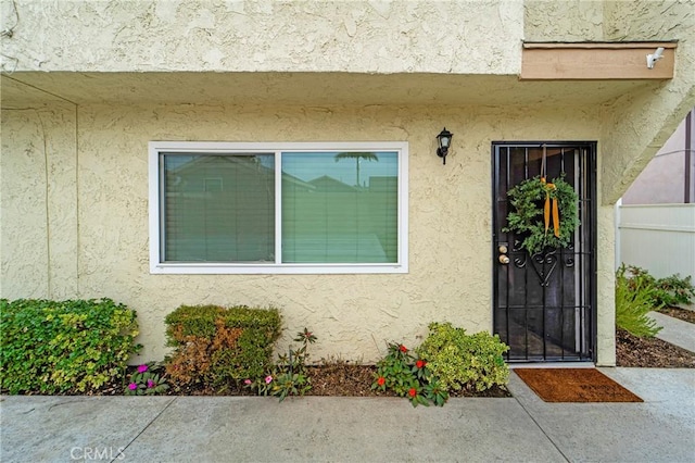 property entrance with stucco siding