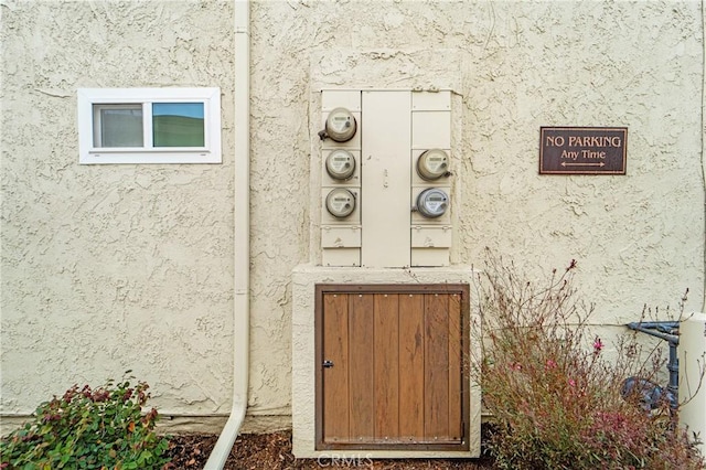 exterior details with electric meter and stucco siding