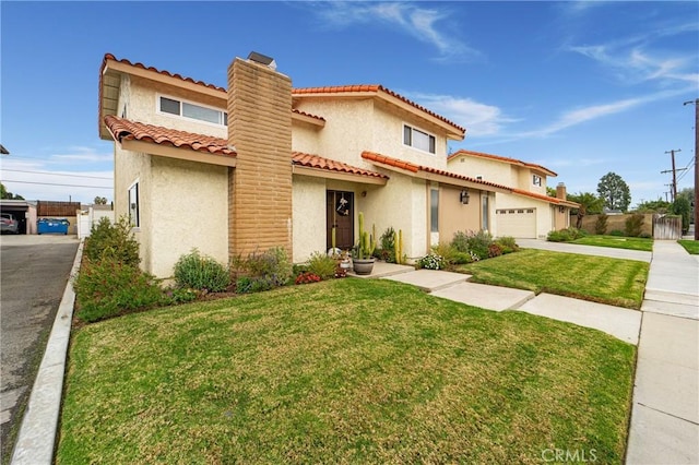 mediterranean / spanish house featuring stucco siding, a front yard, and fence